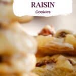 stack of iced rum raisin cookies, one with a bite taken