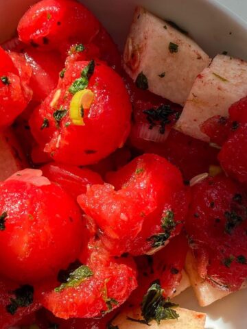 zoomed in watermelon balls, basil, and jicama in salad