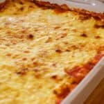 Big white pan of lasagna on wood surface