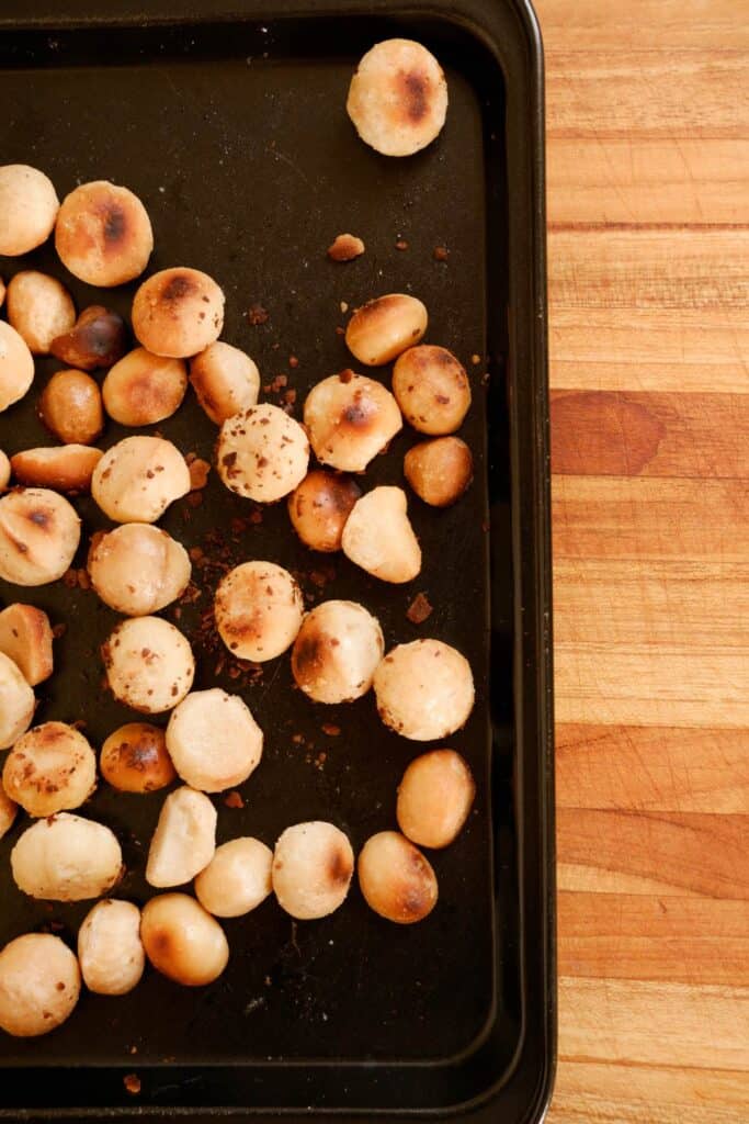 toasted macadamia nuts on a baking sheet