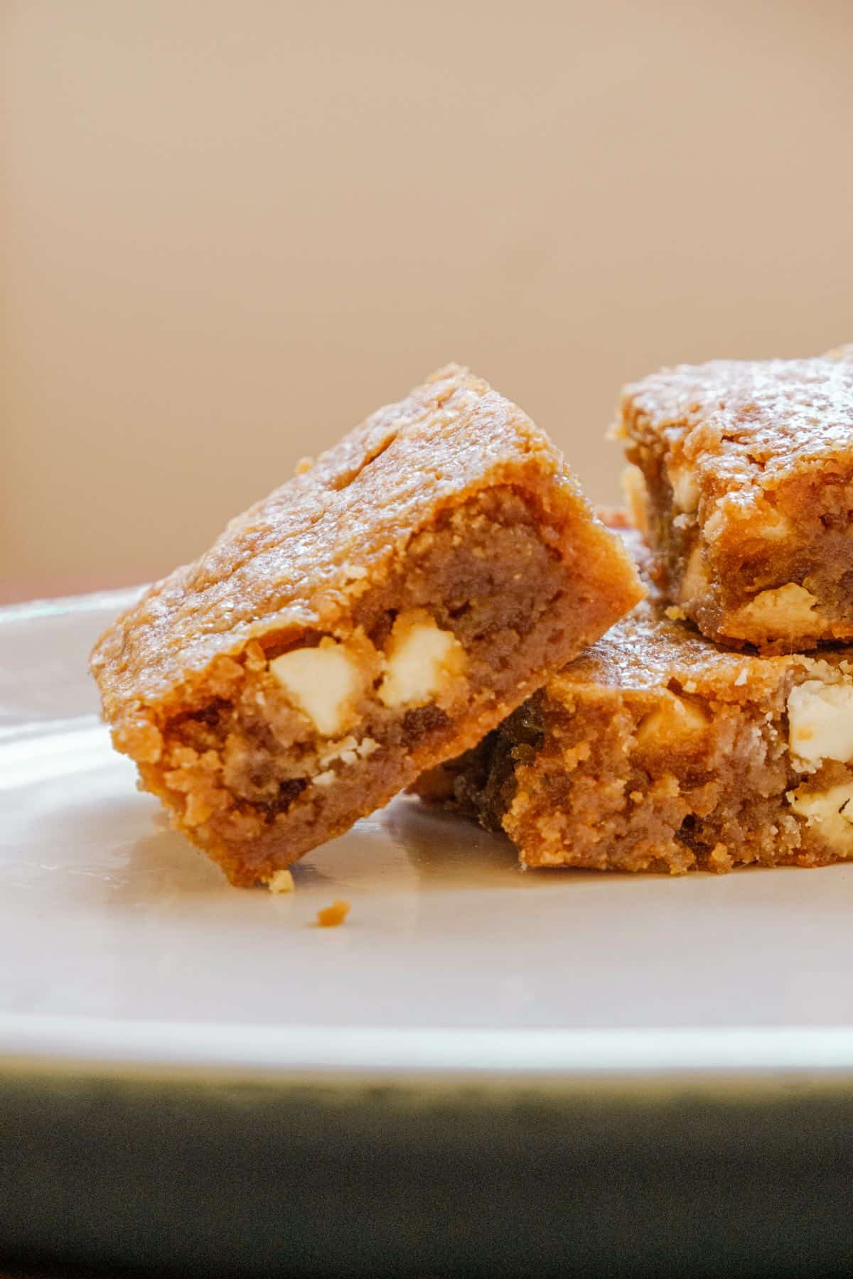 3 stacked bourbon white chocolate brownies; one tipped on its side